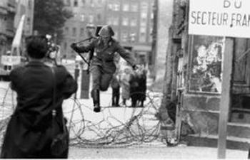Conrad Schumann leaping over barbed wire into West Berlin on 15 August 1961